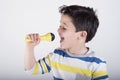 Boy singing to microphone Royalty Free Stock Photo