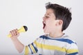 Boy singing to microphone Royalty Free Stock Photo