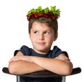 Boy sits astride a chair