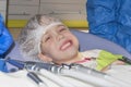 The boy sits at the dentist and happily smile and shows healthy teeth. Blurred dental tools in the foreground