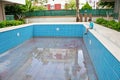 A boy sits by an empty pool. Concept summer 2020. No tourism