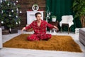 A man sits on a fluffy carpet with his legs crossed. Royalty Free Stock Photo