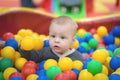 The boy sits in a pile of balls in a dry pool and plays Royalty Free Stock Photo