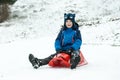 A boy sits on sledge Royalty Free Stock Photo