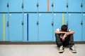 Boy sitting alone resting head on his arms Royalty Free Stock Photo