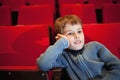 Boy sitting on armchairs at cinema Royalty Free Stock Photo