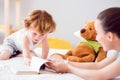 Boy sitting on the bed with mother Royalty Free Stock Photo