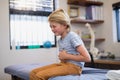 Boy sitting on bed with stomachache Royalty Free Stock Photo