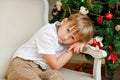 Boy sitting in a chair and sad at Christmas