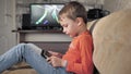 A boy plays on a gadget