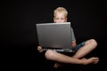 Boy sitting cross legged wearing stripped shirt Royalty Free Stock Photo