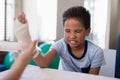 Boy sitting with eyes closed while female therapist wrapping bandage