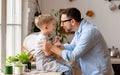 Boy sitting on fathers hands and hugging