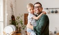 Boy sitting on fathers hands and hugging