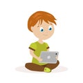 Boy sitting on the floor with a tablet in hands. The child reads or plays on an electronic device. Flat character Royalty Free Stock Photo