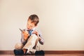 Boy sitting on the floor using a tablet absorbed in it Royalty Free Stock Photo