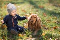 Boy sitting on the grass with a dog Royalty Free Stock Photo