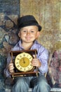 Boy sitting holding clocks in the hands of a waiting midnight Royalty Free Stock Photo
