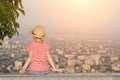 Boy sitting and looking at the city from a height. Rear view, evening time Royalty Free Stock Photo