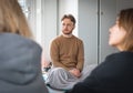 Boy sitting on a mat with a blanket during a yoga class or group activity