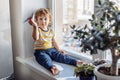 Boy sitting near window. Stay home concept, Coronavirus Covid-19 quarantine