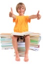 Boy sitting on piles of books