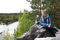Boy sitting on rock above lake in marble canyon Royalty Free Stock Photo