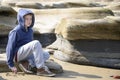 Boy sitting on rocks Royalty Free Stock Photo