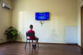 A boy sitting in a room in front of the monitor