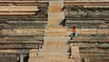 A boy sitting on ruines in India