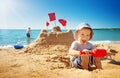 Boy sitting smiling at the beach Royalty Free Stock Photo