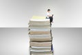 Boy sitting on a stack of books. Royalty Free Stock Photo