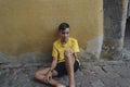 Boy sitting on the street floor