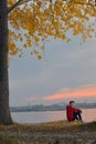 Boy sitting at sunset