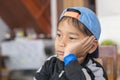 Boy sitting on the table, thinking about something Royalty Free Stock Photo