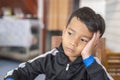 Boy sitting on the table, thinking about something Royalty Free Stock Photo