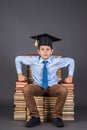 Boy sitting on the throne from books, education funny ide