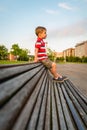 Boy sitting on the top of bench park relaxing Royalty Free Stock Photo