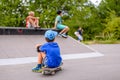 Boy sitting watching his friends at the skate park Royalty Free Stock Photo