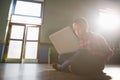 Boy sitting on wooden floor using laptop Royalty Free Stock Photo