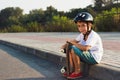 Boy sitts with a skateboards outdoors Royalty Free Stock Photo