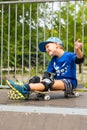 Boy on Skateboard Making Excited Hand Gesture Royalty Free Stock Photo