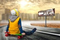 Boy on a skateboard,skate on the road.The little boy in the style of Hip-Hop .The Young Rapper.Cool rap DJ.Children`s fashion. Royalty Free Stock Photo
