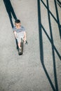 Boy skates on skateboard on asphalt road Royalty Free Stock Photo