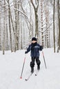 Boy ski running in winter forest Royalty Free Stock Photo