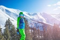 Boy in ski or snowboard outfit stand over the snow mountain Royalty Free Stock Photo