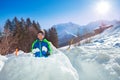 Boy in ski winter outfit prepare snowballs inside snow fortress Royalty Free Stock Photo