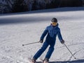 Boy Skier With protective Helmet and Ski Mask having Fun on a Snowy Ski Slope in the Italian Dolomites Mountains