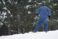 Boy skier in a ski suit and hat standing on snowy slope . Royalty Free Stock Photo