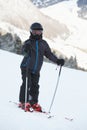 Boy skier stands on snowy slope Royalty Free Stock Photo